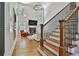 Spacious living room with a stone fireplace, high ceilings, and hardwood staircase at 255 Ashmere Ct, Tyrone, GA 30290