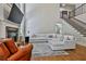Elegant living room with stone fireplace, hardwood floors, and a large comfortable sectional at 255 Ashmere Ct, Tyrone, GA 30290