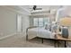 Comfortable bedroom with tray ceiling, plush carpet, and a window with bright, natural light at 255 Ashmere Ct, Tyrone, GA 30290