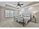 Cozy bedroom with carpet, a tray ceiling, and natural light coming in through the window at 255 Ashmere Ct, Tyrone, GA 30290