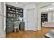 Cozy office space featuring custom shelving, a built-in desk and hardwood floors at 255 Ashmere Ct, Tyrone, GA 30290