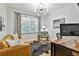 Bright office featuring a leather sofa, modern desk, and hardwood floors at 255 Ashmere Ct, Tyrone, GA 30290