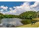Scenic pond with a bench surrounded by trees and lush greenery at 255 Ashmere Ct, Tyrone, GA 30290