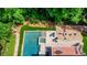 Aerial view of a backyard featuring a sparkling pool, spa, and an outdoor area with a fire pit at 255 Ashmere Ct, Tyrone, GA 30290