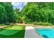 Backyard with a pool, spa, and a putting green for relaxation at 255 Ashmere Ct, Tyrone, GA 30290