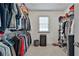 Organized walk-in closet with shelving, hanging racks, carpeted floor and a window at 255 Ashmere Ct, Tyrone, GA 30290