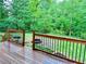 Private backyard with a fire pit, grill, and lush greenery, providing a serene outdoor space at 1345 Starboard Way, Cumming, GA 30041