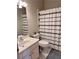Bathroom featuring white sink, toilet, and shower with decorative shower curtain at 1345 Starboard Way, Cumming, GA 30041