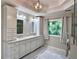 Bright bathroom featuring double sinks, granite countertops, and ample storage at 1345 Starboard Way, Cumming, GA 30041