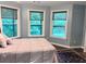 Well-lit bedroom featuring hardwood floors and windows with views of the backyard at 1345 Starboard Way, Cumming, GA 30041