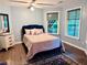 Comfortable bedroom with hardwood floors, and natural light from large windows overlooking a backyard at 1345 Starboard Way, Cumming, GA 30041