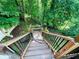 Stairway that leads to a private bench nestled in a lush, wooded backyard at 1345 Starboard Way, Cumming, GA 30041