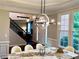 Dining room features designer lighting, a large window with a view of the outdoors, and a marble-top table at 1345 Starboard Way, Cumming, GA 30041
