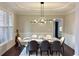 Bright dining room with modern light fixture, marble table, and elegant seating at 1345 Starboard Way, Cumming, GA 30041
