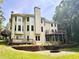 Two-story home features a large deck, patio, and well-maintained backyard at 1345 Starboard Way, Cumming, GA 30041