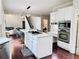 Open-concept kitchen with large island, built-in microwave, and stainless steel oven at 1345 Starboard Way, Cumming, GA 30041