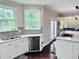 Kitchen featuring white cabinets, stainless steel appliances, and a tile backsplash at 1345 Starboard Way, Cumming, GA 30041