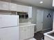 Kitchen with white cabinets and countertops and stainless steel microwave at 1345 Starboard Way, Cumming, GA 30041