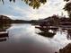 This lake view features a private dock with a covered boat slip and plenty of room to enjoy the water at 1345 Starboard Way, Cumming, GA 30041