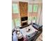 Bright living room features a floor-to-ceiling stone fireplace, plush seating, and large windows with backyard views at 1345 Starboard Way, Cumming, GA 30041