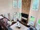 Open living room features a stone fireplace, large windows providing natural light, and hardwood flooring at 1345 Starboard Way, Cumming, GA 30041