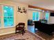 Open concept living room with large windows, wood beams, modern seating and decor at 1345 Starboard Way, Cumming, GA 30041