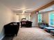 Spacious living room with hardwood floors, large windows, and a view into the bedroom at 1345 Starboard Way, Cumming, GA 30041