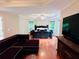 Main bedroom featuring a sitting area, tray ceilings, and hardwood floors at 1345 Starboard Way, Cumming, GA 30041