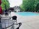 Community pool area offers seating and umbrellas for relaxation by the water at 1345 Starboard Way, Cumming, GA 30041