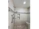 Tiled shower with mosaic accent stripe and built-in shower niche at 1345 Starboard Way, Cumming, GA 30041