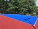 The property includes a vibrant blue and red sport court, ideal for basketball, soccer, and active recreation at 1345 Starboard Way, Cumming, GA 30041