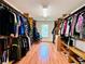 Spacious walk-in closet features ample storage with shelves and hanging racks for clothing at 1345 Starboard Way, Cumming, GA 30041