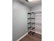 Walk-in closet with wood floors and organizational shelving at 1345 Starboard Way, Cumming, GA 30041