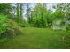 Lush green backyard with mature trees and landscaping at 1712 Venetian Sw Dr, Atlanta, GA 30311