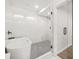 Spa-like bathroom showcases a glass-enclosed shower and a sleek, modern soaking tub for ultimate relaxation at 1712 Venetian Sw Dr, Atlanta, GA 30311