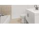 Bathroom featuring tile flooring, a white vanity, and a tub, all complemented by a neutral color scheme at 1712 Venetian Sw Dr, Atlanta, GA 30311
