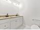 Bathroom with double sink vanity, granite countertop, and toilet set against a clean, bright backdrop at 1712 Venetian Sw Dr, Atlanta, GA 30311