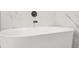 Close-up on a sleek soaking tub paired with modern fixtures and elegant tile for a spa-like retreat at 1712 Venetian Sw Dr, Atlanta, GA 30311