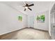 A bedroom featuring sleek floors, a ceiling fan, and windows providing natural light at 1712 Venetian Sw Dr, Atlanta, GA 30311