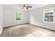 Bright bedroom showcasing sleek floors, a ceiling fan, and two sun-filled windows at 1712 Venetian Sw Dr, Atlanta, GA 30311