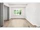 Bright bedroom with sleek flooring, a bay window offering a view, and adjacent closet space at 1712 Venetian Sw Dr, Atlanta, GA 30311