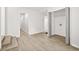 Hallway featuring sleek floors, stair access, and a closet/laundry area at 1712 Venetian Sw Dr, Atlanta, GA 30311