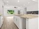 Eat-in kitchen with granite countertops, shaker cabinets, and an adjacent open-concept living area at 1712 Venetian Sw Dr, Atlanta, GA 30311