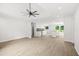 Open-concept living area with recessed lights, ceiling fan and an adjacent kitchen with granite countertops at 1712 Venetian Sw Dr, Atlanta, GA 30311