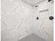 Shower features marble tile, multiple shower heads, and a soap niche for a luxurious bathing experience at 1712 Venetian Sw Dr, Atlanta, GA 30311
