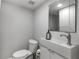Modern powder room with a sleek sink, modern faucet and vanity, illuminated by a recessed light at 2270 Emerald Dr, Jonesboro, GA 30236