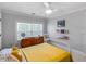 Comfortable bedroom with a yellow bedspread, vintage decor, and neutral colored walls and carpet at 2270 Emerald Dr, Jonesboro, GA 30236