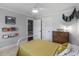 Cozy bedroom with classic decor, a comfortable bed, and convenient built-in shelving for books at 2270 Emerald Dr, Jonesboro, GA 30236