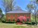 Charming brick home with a well-manicured lawn and a beautiful flowering tree in the front yard at 2270 Emerald Dr, Jonesboro, GA 30236