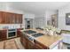 Kitchen featuring dark wood cabinetry, granite countertops, stainless steel appliances, and an eat-in island at 2270 Emerald Dr, Jonesboro, GA 30236